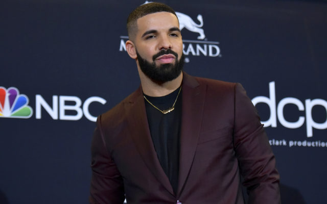 Drake Hands Hundred-Dollar Bills To Man In Street
